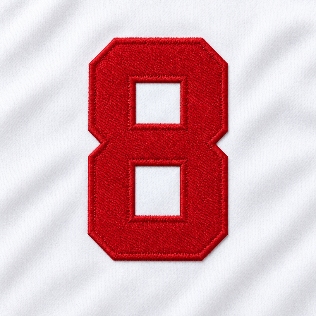Close-up product mockup of the red embroidered number 8, showing raised stitched edges and white jersey fabric.