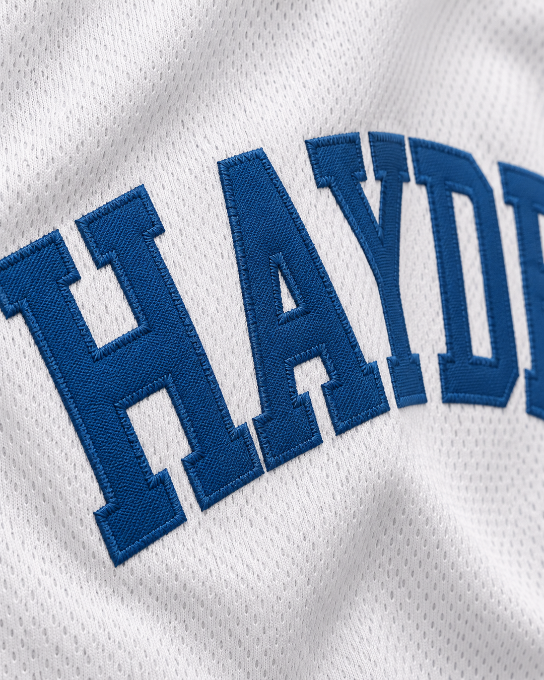Embroidery detail product mockup of Mike O'Donnell 0 Hayden High School Basketball Jersey.