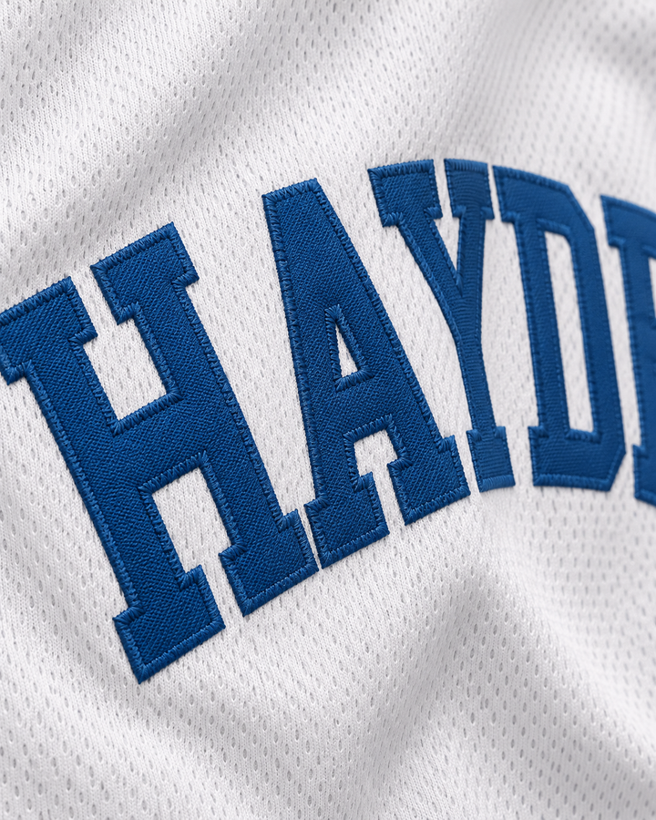 Embroidery detail product mockup of Mike O'Donnell 0 Hayden High School Basketball Jersey.