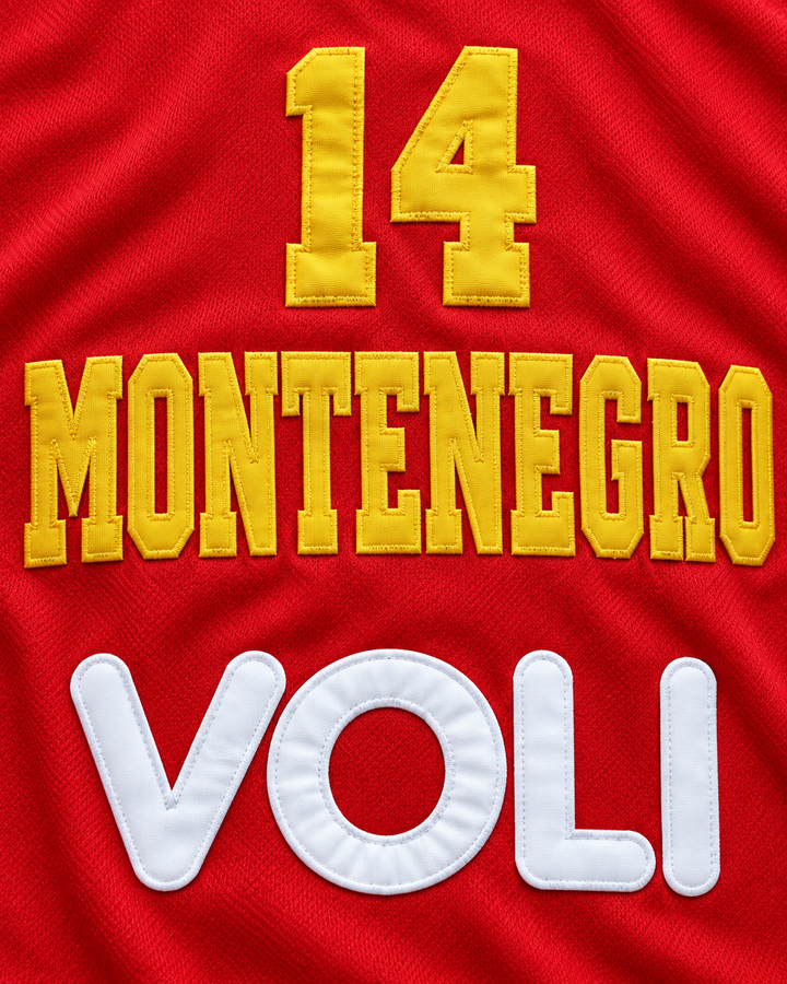 Embroidery detail product mockup of Nikola Pekovic 14 Montenegro Basketball Jersey, showing raised applique edges, fine stitching and fabric texture.