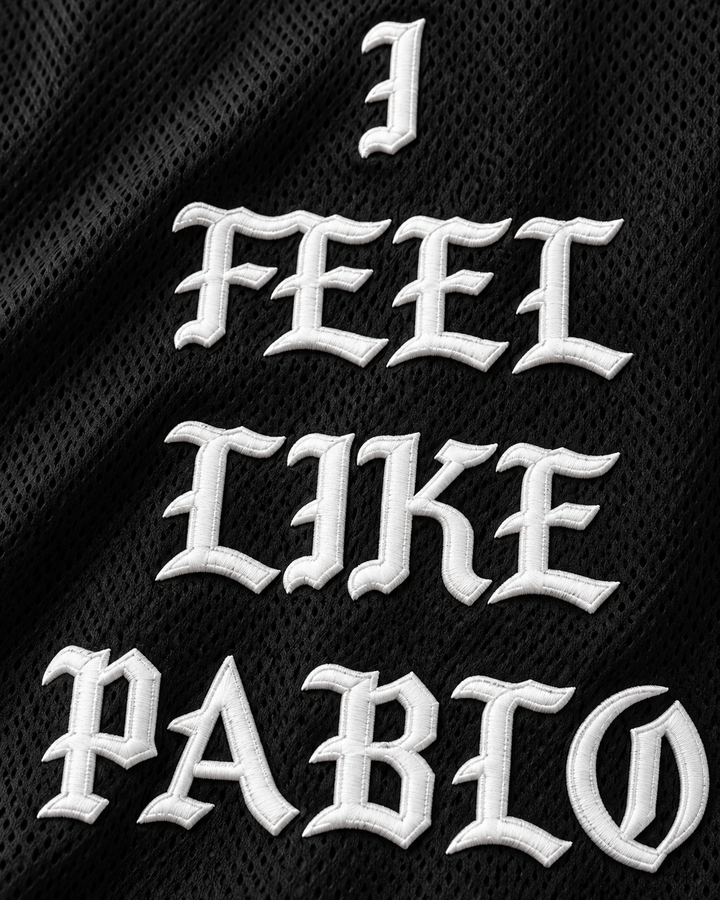 Embroidery detail product mockup of Pablo Escobar I Feel Like Pablo Black Basketball Jersey, showing raised applique edges, fine stitching and fabric texture.