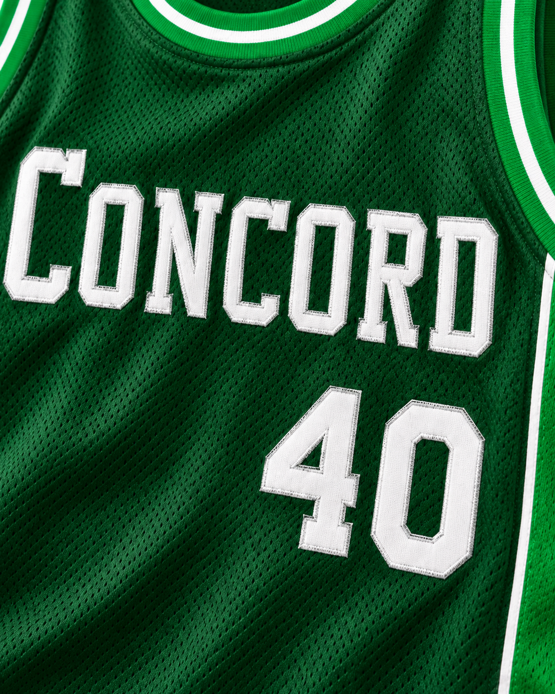 Embroidery detail product mockup of Shawn Kemp 40 Concord High School Minutemen Away Basketball Jersey, showing raised applique edges, fine stitching and fabric texture.
