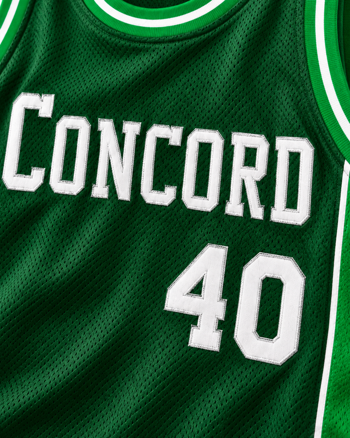 Embroidery detail product mockup of Shawn Kemp 40 Concord High School Minutemen Away Basketball Jersey, showing raised applique edges, fine stitching and fabric texture.