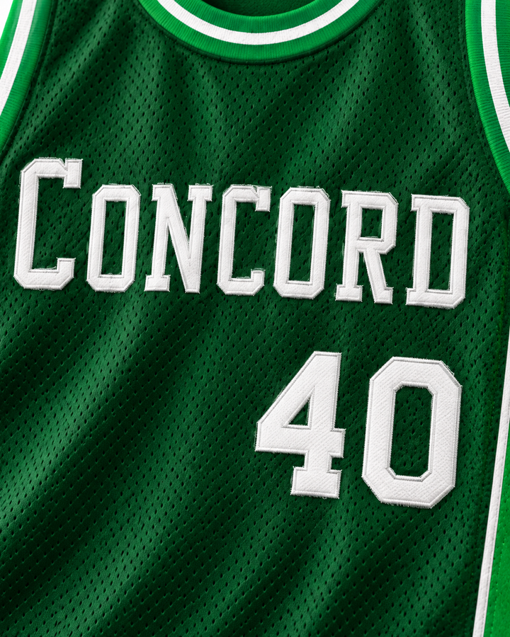 Embroidery detail product mockup of Shawn Kemp 40 Concord High School Minutemen Green Basketball Jersey, showing raised applique edges, fine stitching and fabric texture.