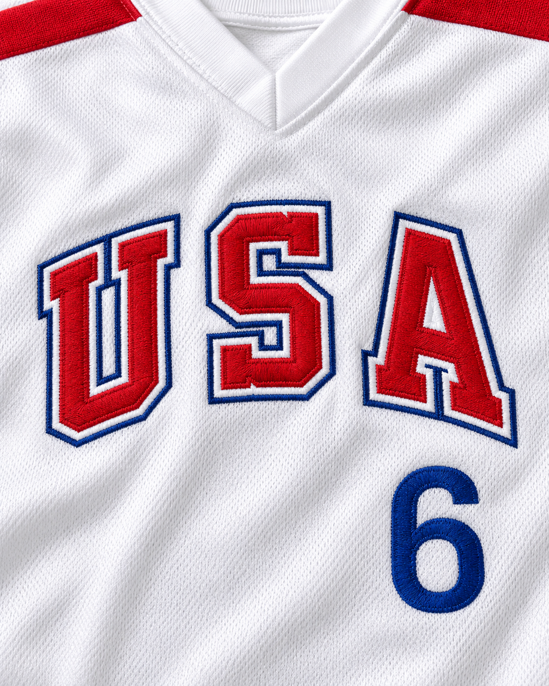 Embroidery detail product mockup of Sid Akins 6 1984 USA Team White Baseball Jersey.