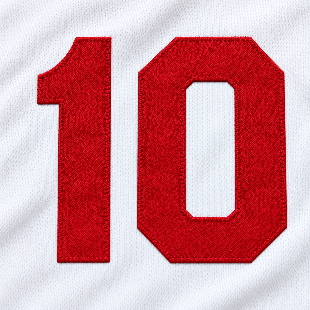 Close-up product mockup of the red number 10 applique with raised stitched edges on white jersey fabric.
