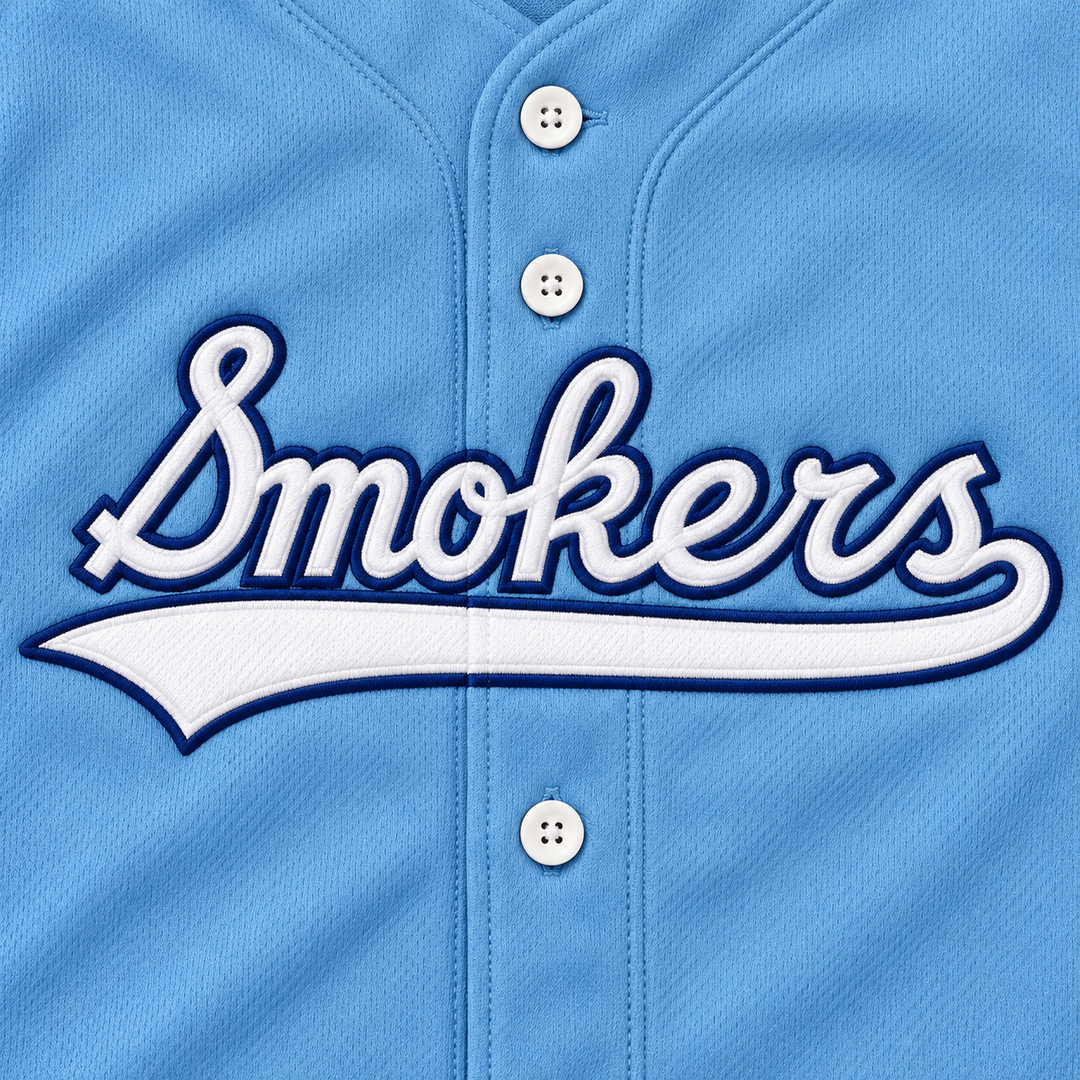 Close-up product mockup of white Smokers script and underline with navy embroidered edges on light blue jersey fabric.