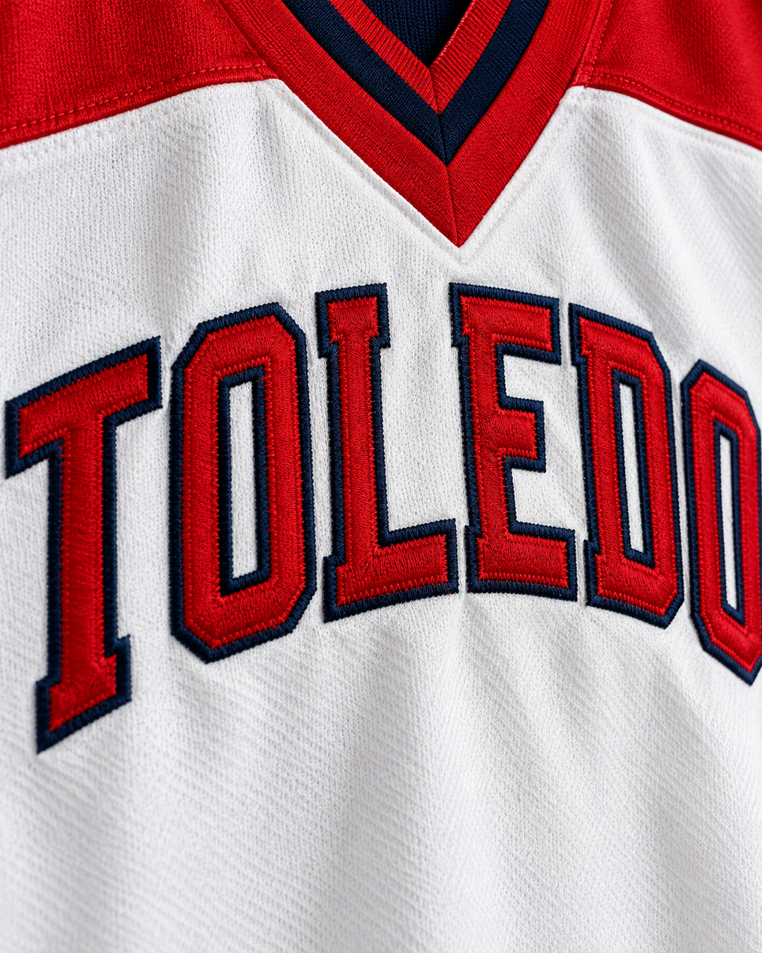 Embroidery detail product mockup of Toledo Mud Hens 9 White and Navy Blue Pullover Baseball Jersey.