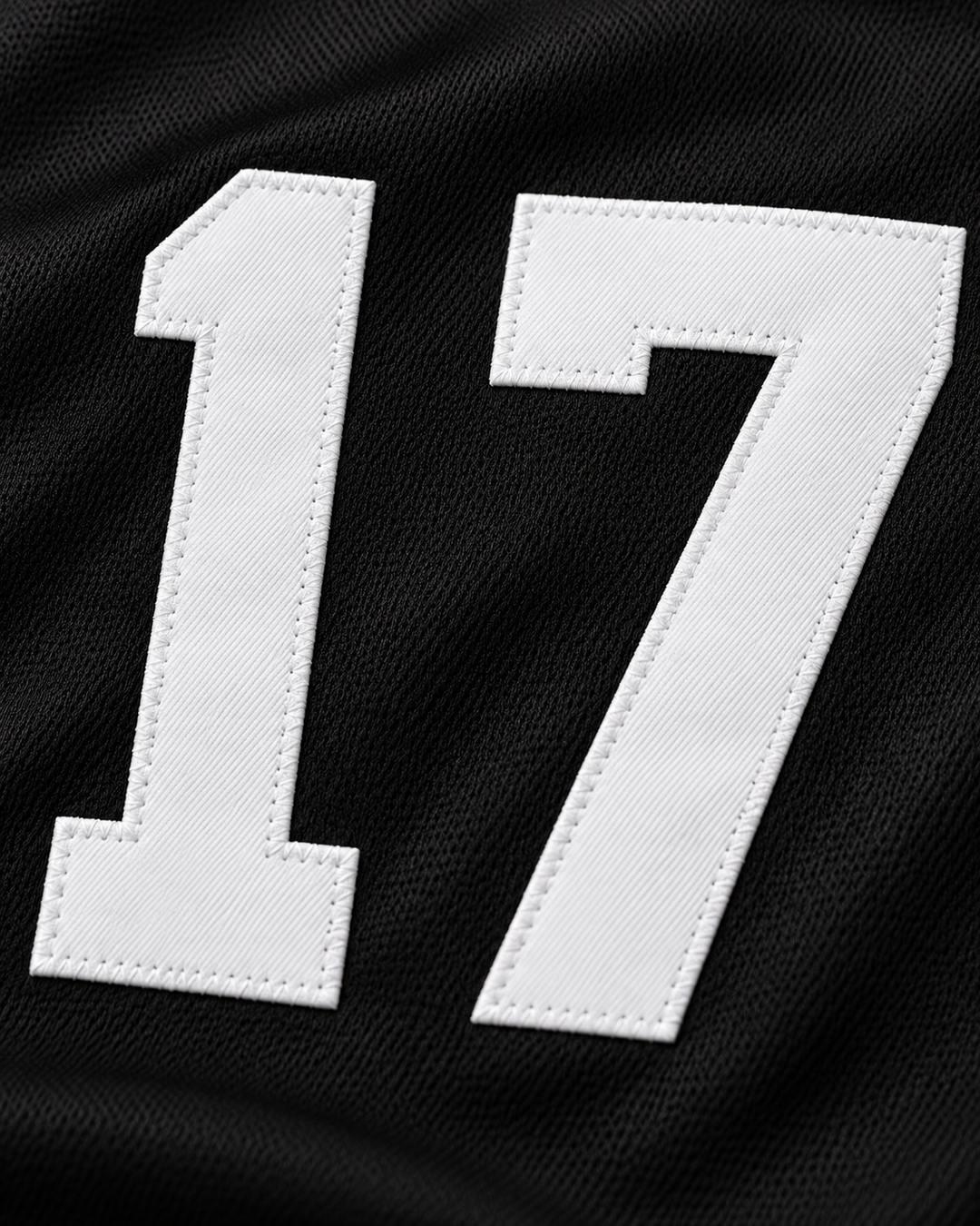 Embroidery detail product mockup of Tom Peterson 17 Aardvarks Rock N' Jock Baseball Jersey.