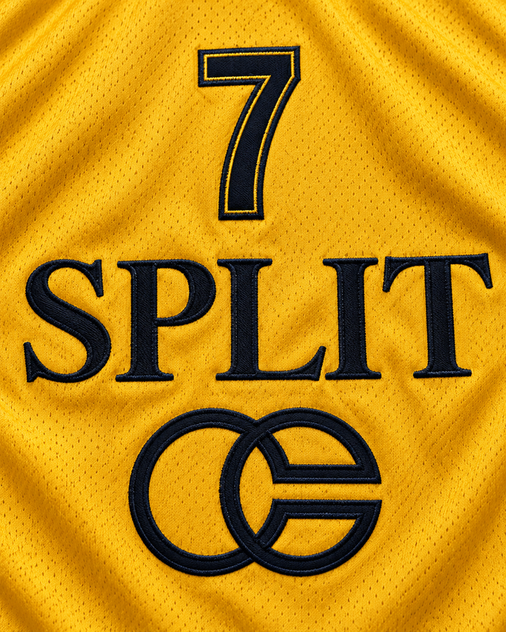 Embroidery detail product mockup of Toni Kukoc 7 KK Split Jugoplastika Basketball Jersey, showing raised applique edges, fine stitching and fabric texture.