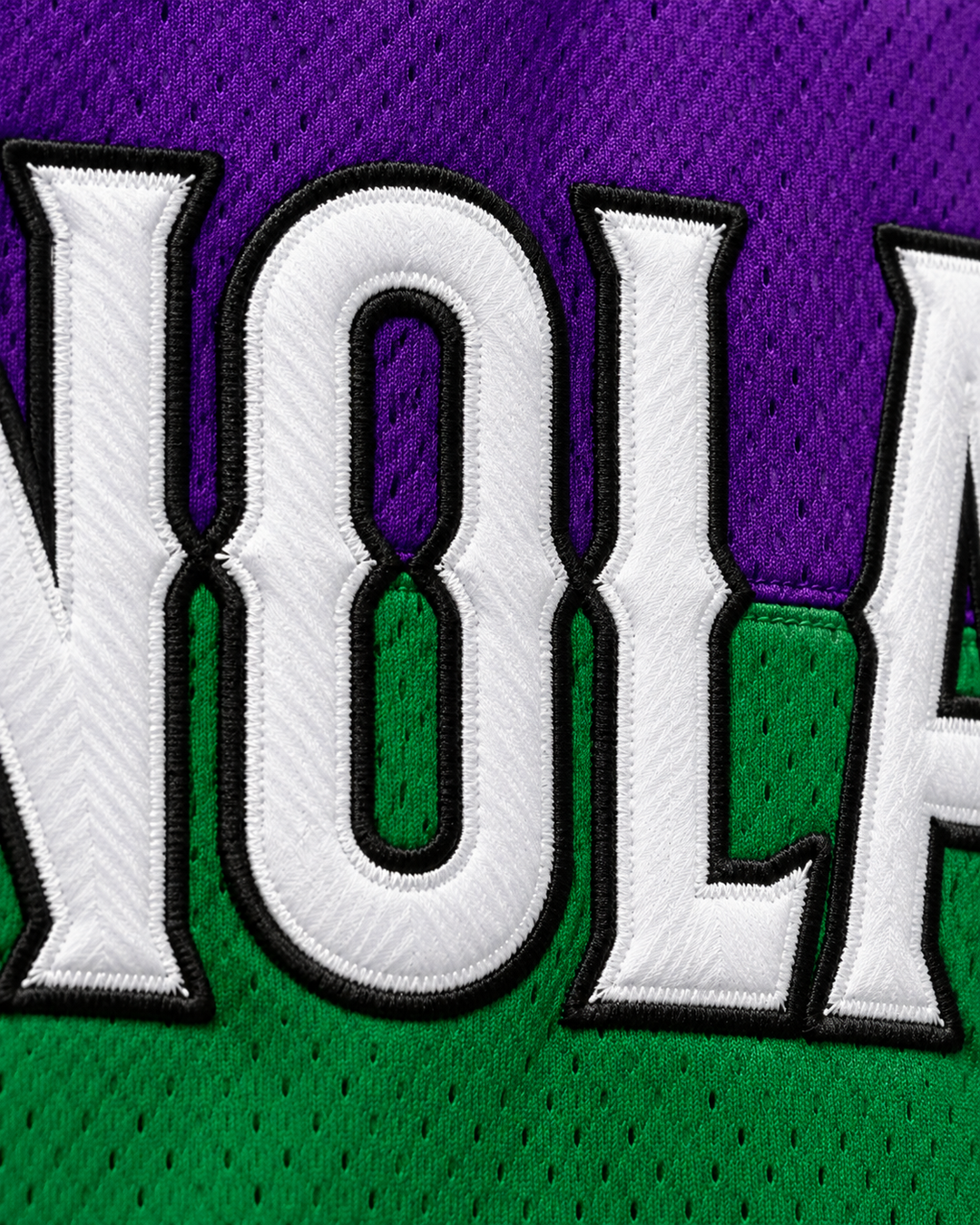 Embroidery detail product mockup of U.N.L.V. 92 NOLA Bounce White Basketball Jersey.