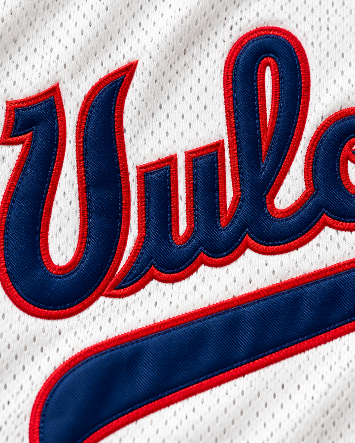 Embroidery detail product mockup of University of Hawaii At Hilo 24 Vulcans White Basketball Jersey.