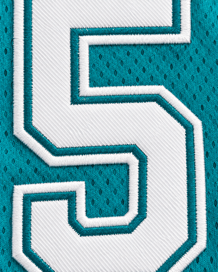 Embroidery detail product mockup of Vakidis 55 Flint Tropics Teal Semi Pro Basketball Jersey.