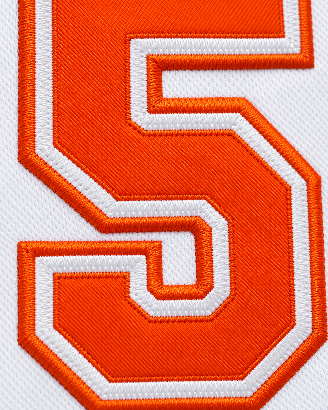 Embroidery detail product mockup of Vakidis 55 Flint Tropics White Semi Pro Basketball Jersey.