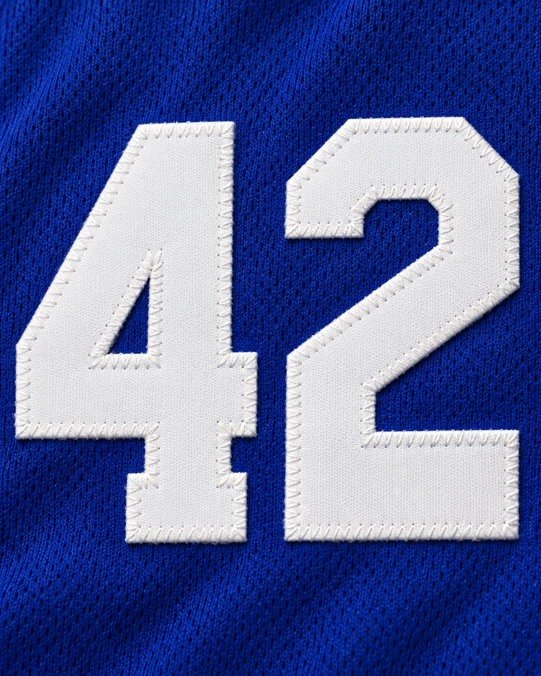 Embroidery detail product mockup of Vin Baker 42 Pyongyang Blue Basketball Jersey.