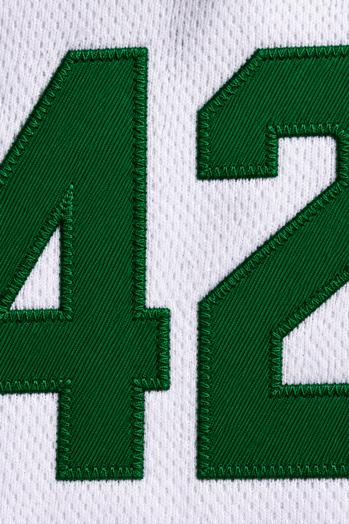 Embroidery detail product mockup of Vin Baker 42 Pyongyang White Basketball Jersey.