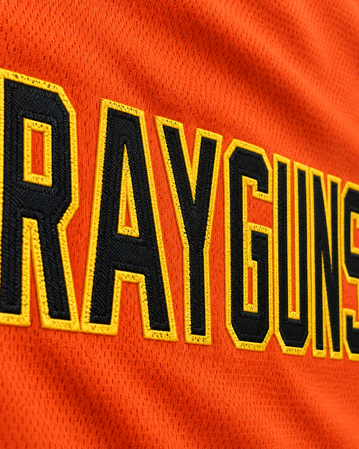 Embroidery detail product mockup of Vince Carter 15 Roswell Rayguns Orange Basketball Jersey.