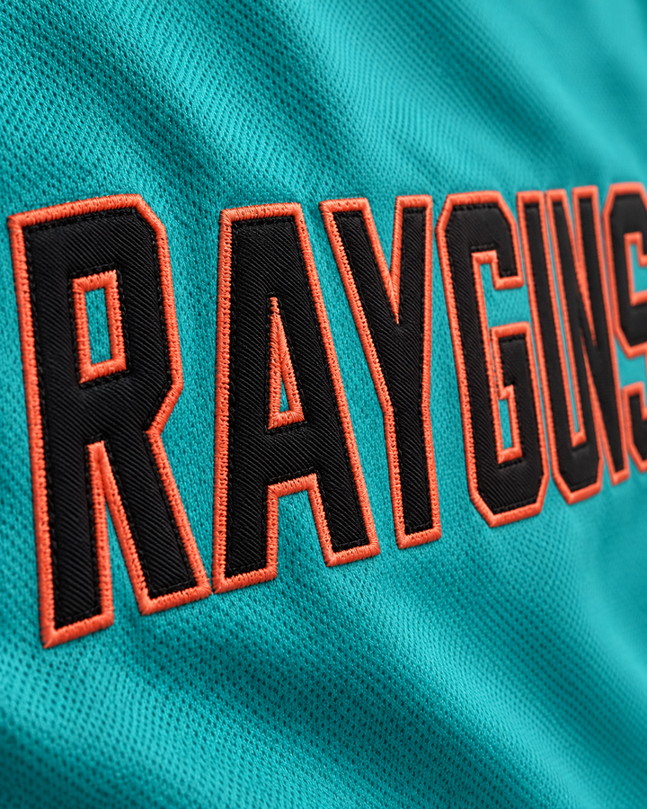 Embroidery detail product mockup of Vince Carter 15 Roswell Rayguns Teal Basketball Jersey.