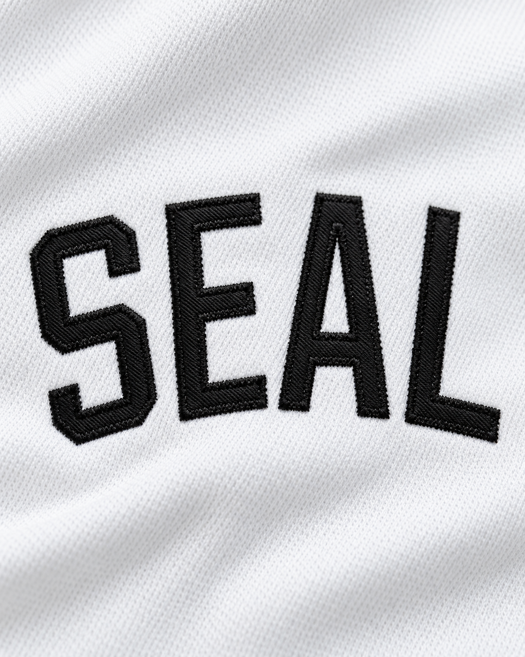 Embroidery detail product mockup of VJ Kevin Seal Salamanders Rock N' Jock 1990 Baseball Jersey.