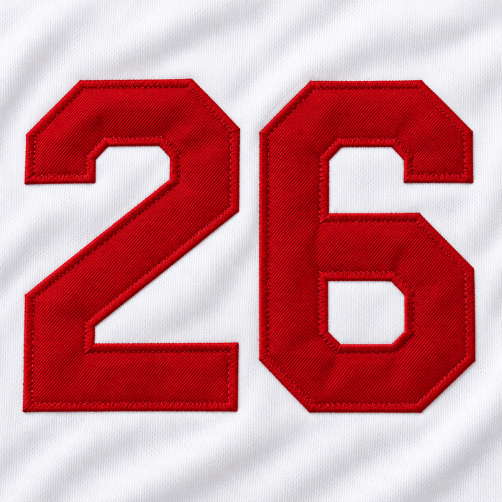 Close-up product mockup of the red number 26 applique with raised stitched edges on white jersey fabric.