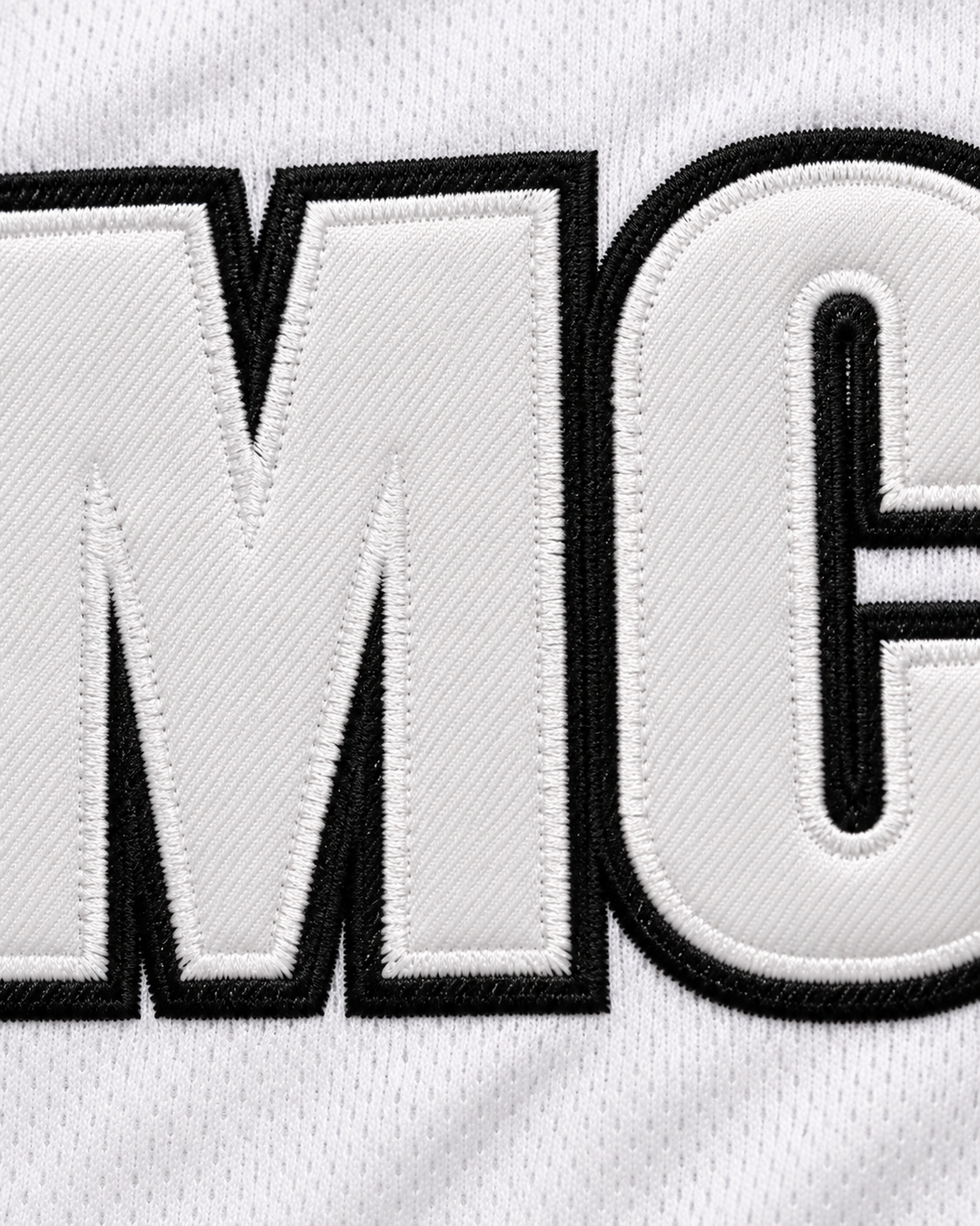 Embroidery detail product mockup of YMCMB Young Money Cash Money Billionaires White Basketball Jersey.